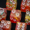 ☠️16mm "Ember Skull" d6 – Red & Gold Swirl with White Skull Pips (Single Die)