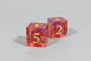 Two transparent red dice with numbers on a wooden surface
