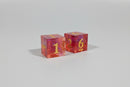 Two transparent dice with numbers on a reflective surface