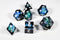 Deep Nether Sharp Edge Resin 7-Dice Dice (Blue-Green and Black w/ White Numbers)